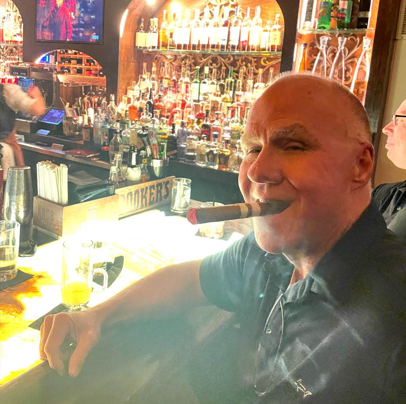 Bob McKay enjoying a drink and cigar